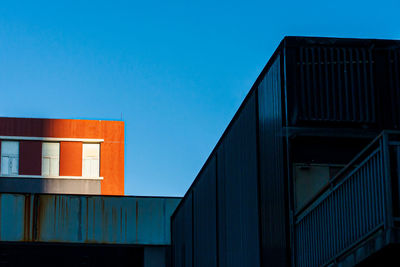 Low angle view of building against clear blue sky
