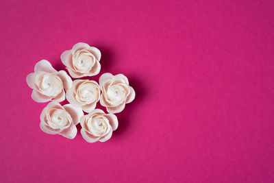 Directly above shot of pearl jewelry on red background