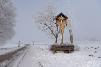 Built structure on snow covered landscape against clear sky