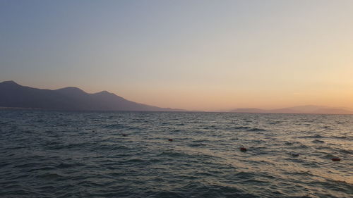 Scenic view of sea against clear sky during sunset