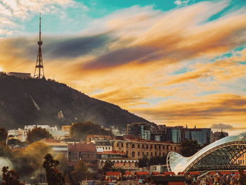 High angle view of buildings and mountains against sky during sunset