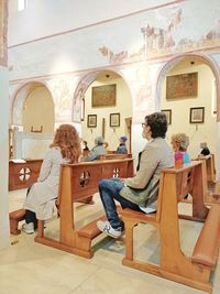 Rear view of people sitting on chair