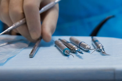 Close-up of dentist hand with dental equipment