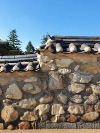 Low angle view of stack on rock against sky