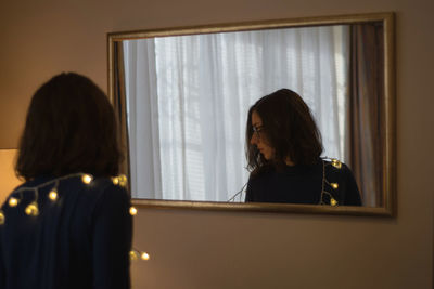Woman standing by window