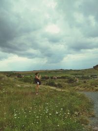 Man standing on field against sky