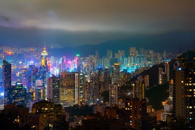 Illuminated cityscape against sky at night