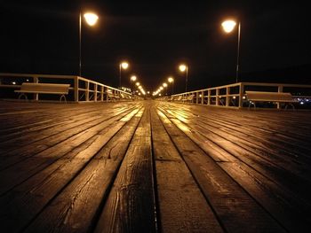 Railroad tracks against sky at night