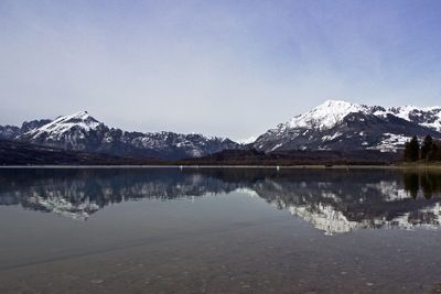 Scenic view of snowcapped mountains against cloudy sky