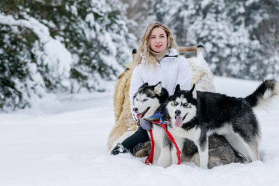 Woman with dog on snow