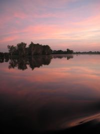 Scenic view of lake against romantic sky at sunset