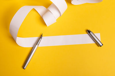 High angle view of pen on yellow table