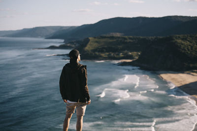 Rear view of man standing on beach