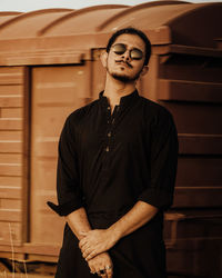 Young man wearing sunglasses standing outdoors