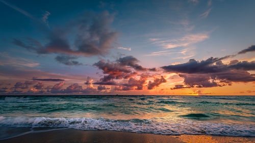 Scenic view of beach against sky during sunset