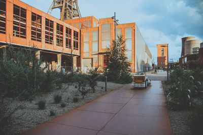 Street amidst buildings in city against sky