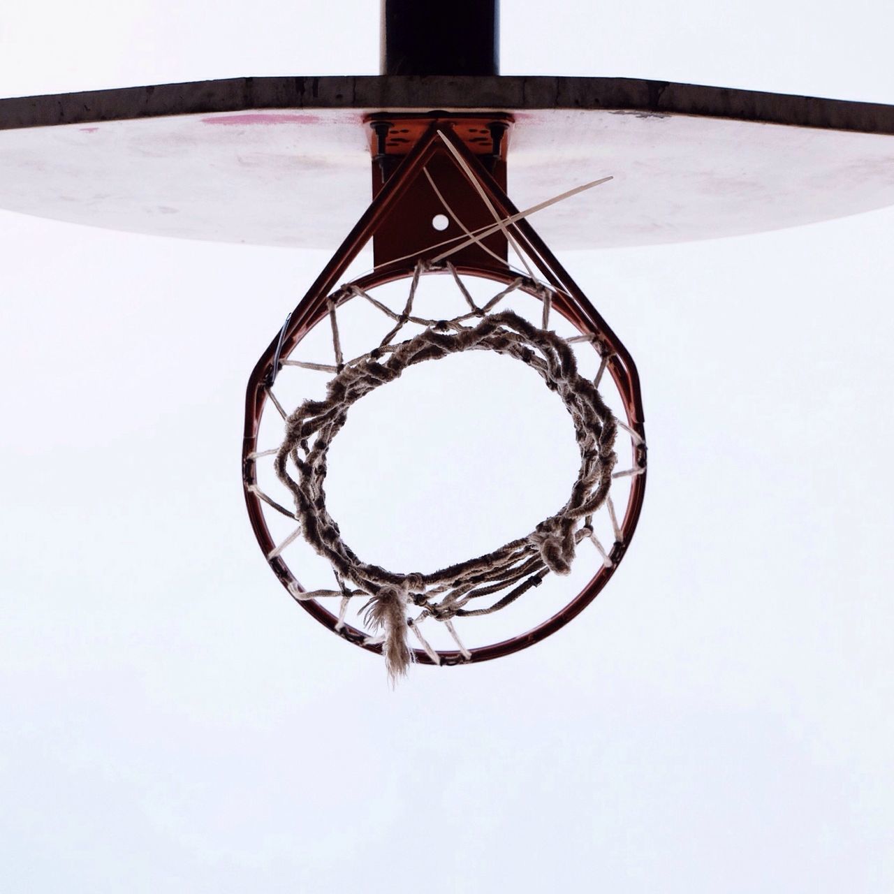 low angle view, built structure, circle, architecture, geometric shape, directly below, metal, design, clear sky, spiral, pattern, shape, day, indoors, spiral staircase, metallic, no people, basketball hoop, sky, close-up