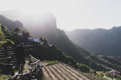 Man standing on mountain against sky