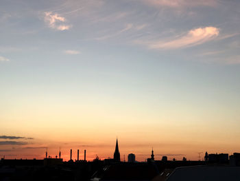 Silhouette buildings against sky during sunset