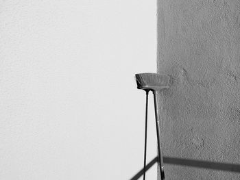 Low angle view of electric lamp against wall