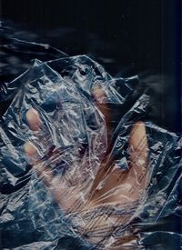 Close-up of human hand holding broken glass