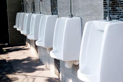 Close up row of outdoor urinals men public toilet