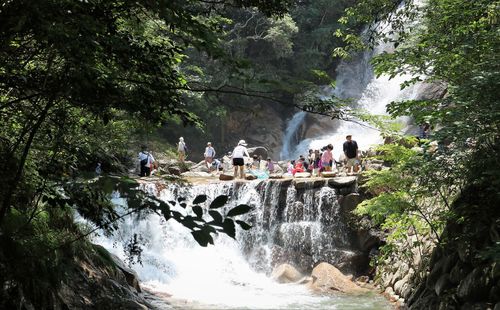 People enjoying at waterfall and river