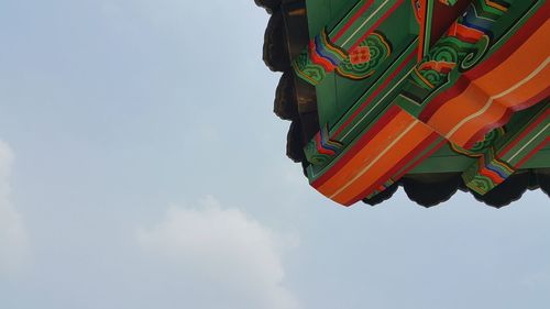 Low angle view of multi colored hanging against sky