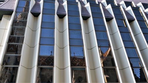 Low angle view of modern building against sky in city