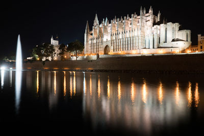 Reflection of illuminated buildings in water at night