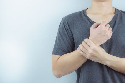 Midsection of woman against white background
