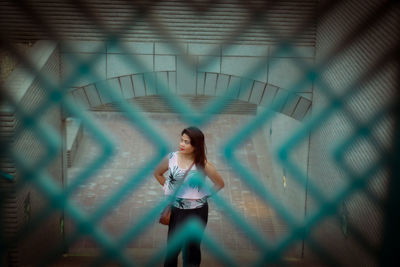 Woman standing against wall