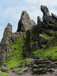 Low angle view of rock formations against sky