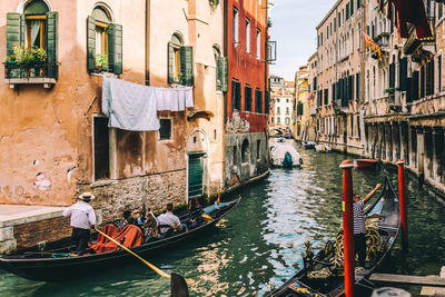 Gondolas amidst buildings in city