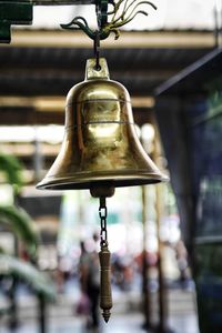 Close-up of electric lamp hanging in temple