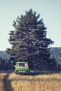 Van on field against clear sky