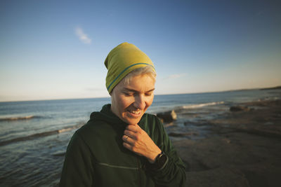 Smiling woman relaxing on coast