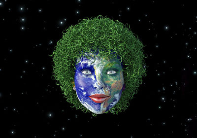 Digital composite image of human face painted as globe against star field