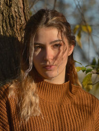 Conceptual autumn portrait in sunny day in park