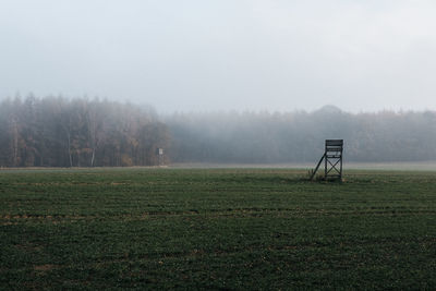 Scenic view of field against sky during foggy weather