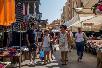 People walking on street market in city