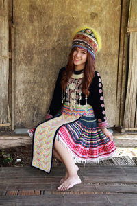 Portrait of a smiling young woman sitting outdoors