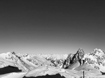 Scenic view of snowcapped mountains against clear sky