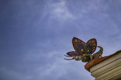 Low angle view of statue against sky