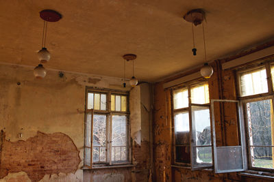 Low angle view of window in abandoned house