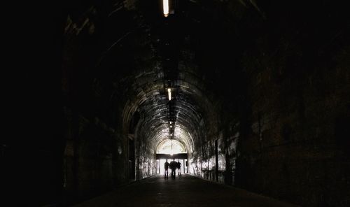 People walking in tunnel