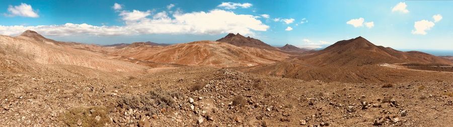 Panoramic view of arid landscape against sky