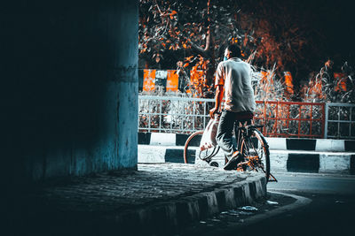 Rear view of man walking on street in city