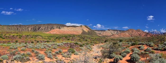 Scenic view of rocky mountains against blue sky