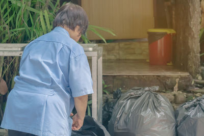 Rear view of man standing at home